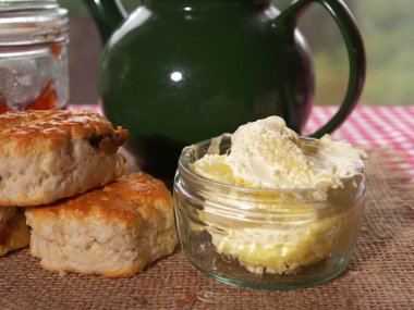 Clotted cream and fresh baked scones medium shot clipart