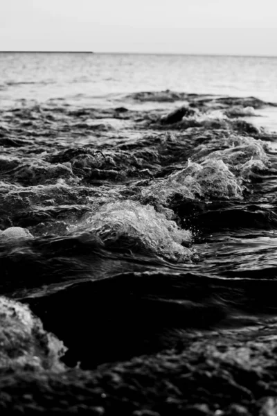 海岸近くの海の波の垂直グレースケールのショット — ストック写真