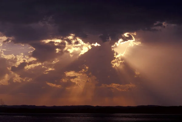 Közelkép Egy Gyönyörű Tengerre Néző Napnyugtakor Nap Sugarai Jönnek Felhők — Stock Fotó
