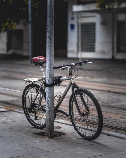 Disparo Vertical Una Bicicleta Atada Poste Aire Libre Durante Día —  Fotos de Stock