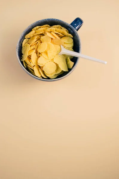 Vertical Shot Corn Flakes Cup Plastic Spoon Isolated Brown Background — Stock Photo, Image