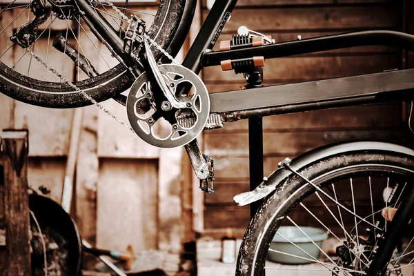 A Bicycle on the assembly stand for maintenance and repair with a blurred background