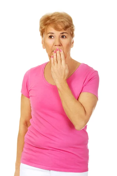 Portrait Senior Surprised Polish Woman Closing Her Mouth Hand Isolated — Stockfoto