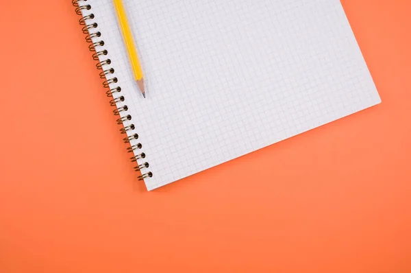 Een Raster Notebook Een Potlood Geïsoleerd Oranje Achtergrond Met Vrije — Stockfoto