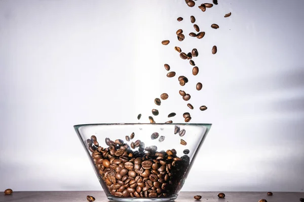 Closeup Black Coffee Beans Pouring Glass Bowl — Stock Photo, Image