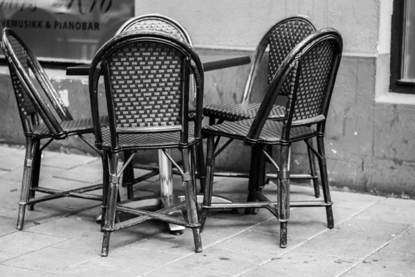 Een Grijswaarden Shot Van Buitenmeubelen Met Een Tafel Rotan Stoelen — Stockfoto