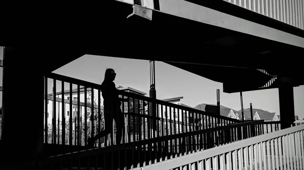 Greyscale Shot Person Walking Stairs Overpass — Stock Photo, Image