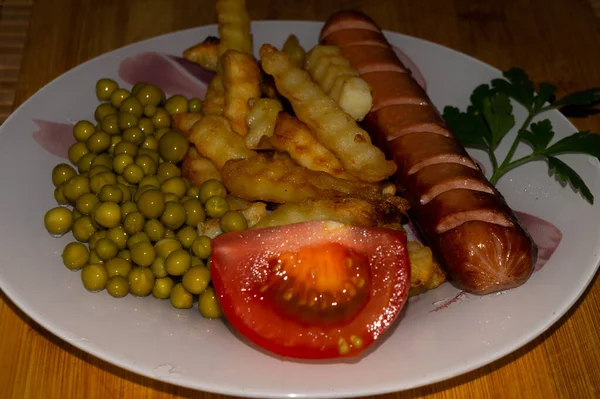 Closeup Delicious Meal Composed Sausage Fries Peas Tomato White Plate — Stock Photo, Image
