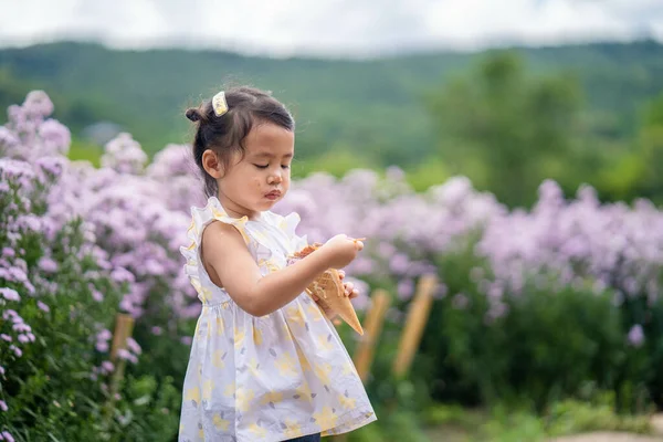 Adorable Little Girl Thailand Eating Snack Meadow Lavender Flowers — Stock Photo, Image