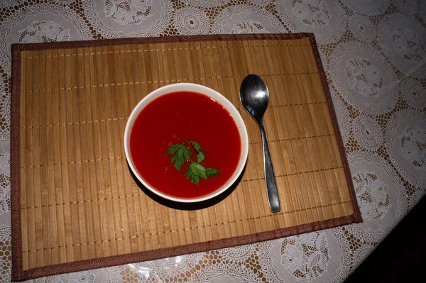 竹のマットにおいしくて健康的なトマトスープのボウルのオーバーヘッドショット — ストック写真