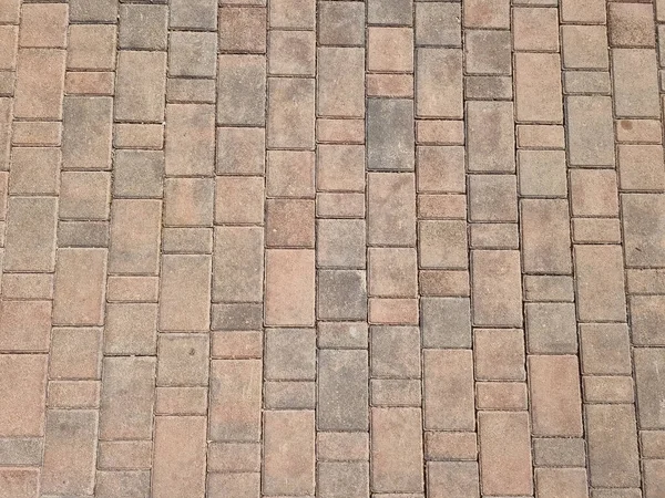 暖かい晴れた日の美しい茶色の石舗装テクスチャのトップビュー — ストック写真