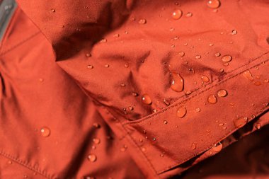 Detail photo of wateproof jacket with water droplets on it. Gore-tex jacket in detail. clipart
