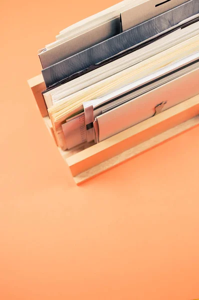 Vertical Shot Filled Documents Wooden Shelf Isolated Orange Background — Stock Photo, Image