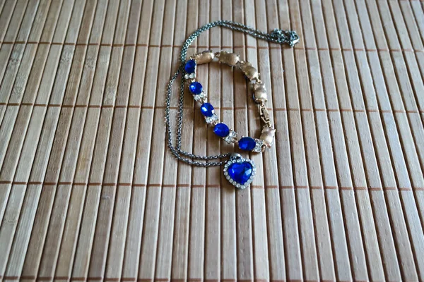 Mavi Mücevherli Bir Bilezik Ahşap Yüzey Üzerinde Kalbi Olan Bir — Stok fotoğraf