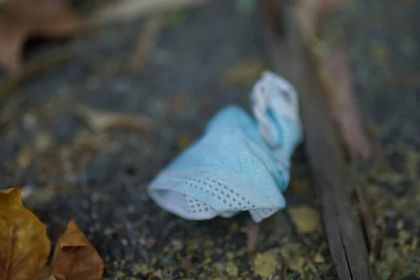 Closeup Shot Folded Medical Facemask Thrown Ground — Stock Photo, Image