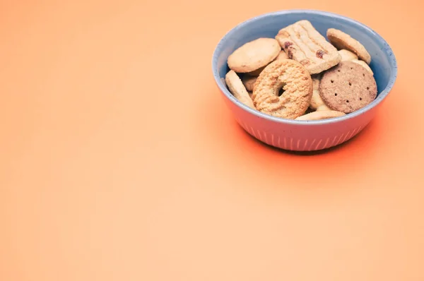 Eine Nahaufnahme Einer Schüssel Kekse Auf Orangefarbenem Hintergrund — Stockfoto