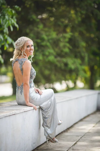 Happy Young Woman Sitting Bench Silver Dress Open Back — стоковое фото