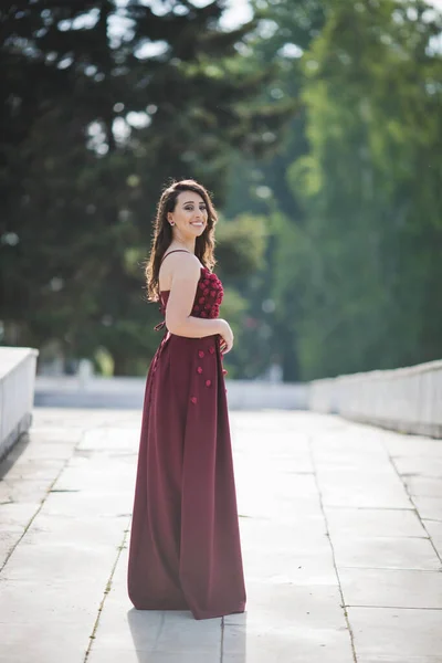Closeup Shot Young Woman Posing Red Dress Pathway Smiling — Foto Stock