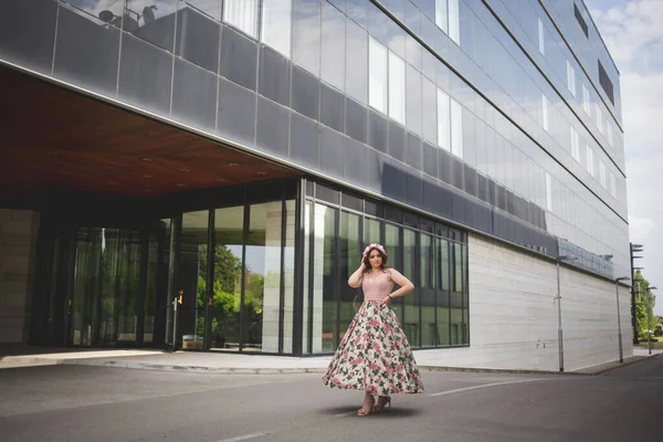 Stylish Woman Standing Front Modern Building Pink Dress Light Wind — Stock fotografie