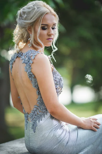 Closeup Shot Shy Blond Woman Sitting Outdoors Silver Dress Open — Stok fotoğraf