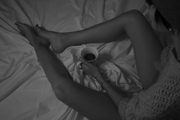 Grayscale Shot Female Holding Cup Coffee Bed — Stock Photo, Image