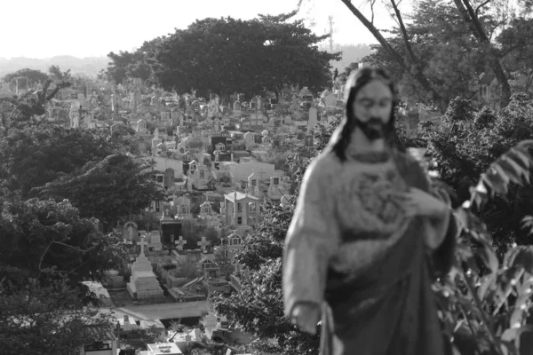 Серый Снимок Статуи Иисуса Кладбища Заднем Плане — стоковое фото