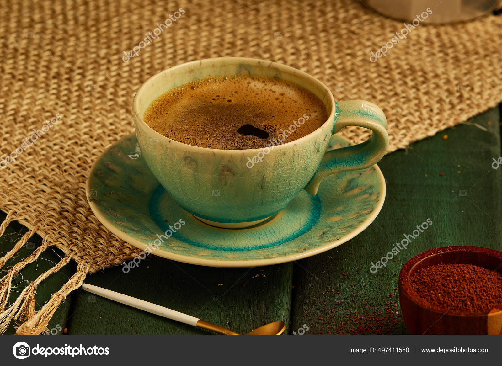 Close-up of espresso coffee in a single shot glass cup with saucer on the  wooden table. Stock Photo