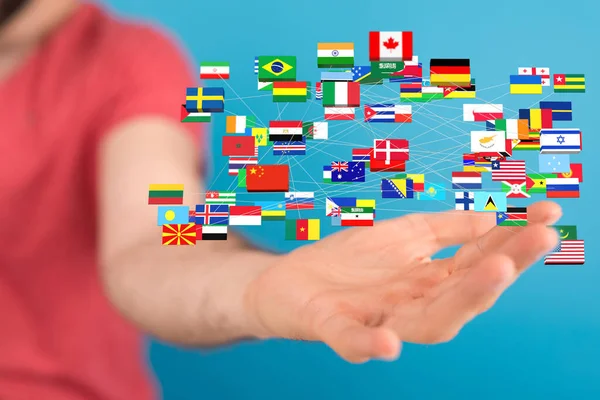 Mužské Ruce Držící Vykreslování Mezinárodních Vlajek — Stock fotografie
