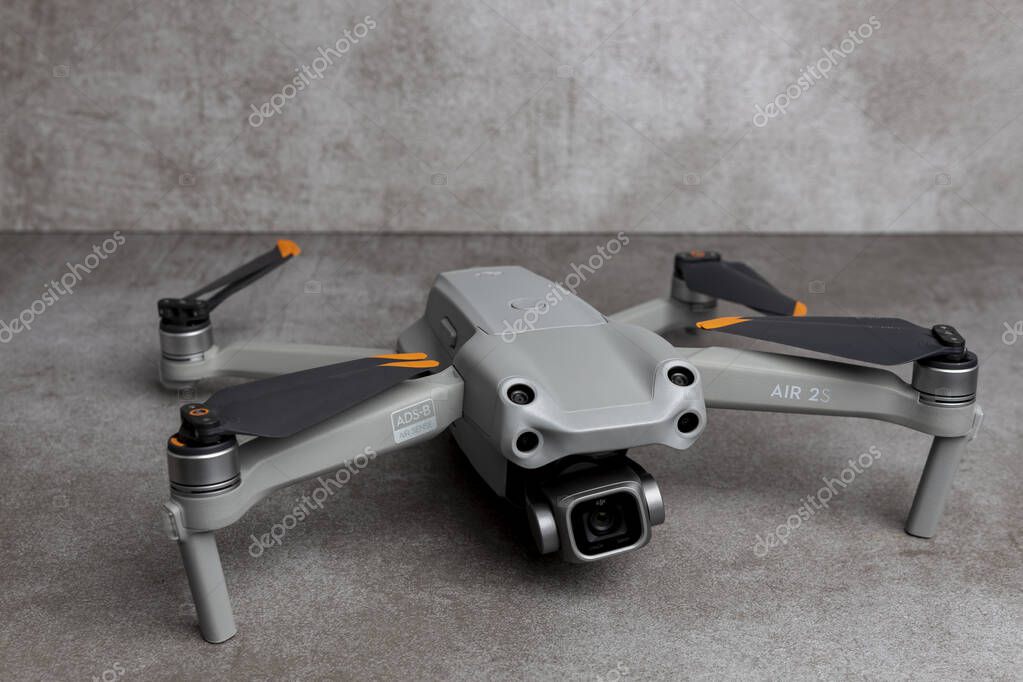 ZUTPHEN, NETHERLANDS - Aug 08, 2021: DJI quadcopter Air 2S drone with folded props on stylish contemporary modern metallic patterned gray backdrop.