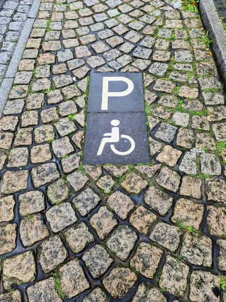 停在室外鹅卵石地上的一个残疾人停车标志的垂直照片 — 图库照片
