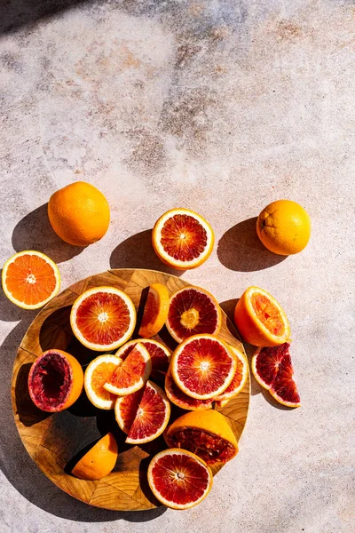Blood Oranges cut, sliced, halved and segmented photographed in direct sunlight
