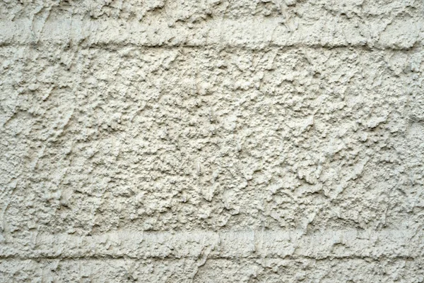 壁紙や背景に使用されるラフな漆喰壁のテクスチャのクローズアップショット — ストック写真