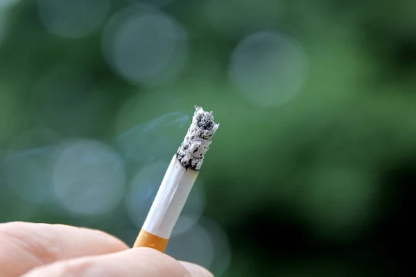 Lit Cigarette Blurred Background Bokeh Lights Royalty Free Stock Images