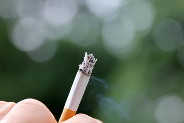 Hand Holding Lit Cigarette Blurred Background Bokeh Lights Royalty Free Stock Photos