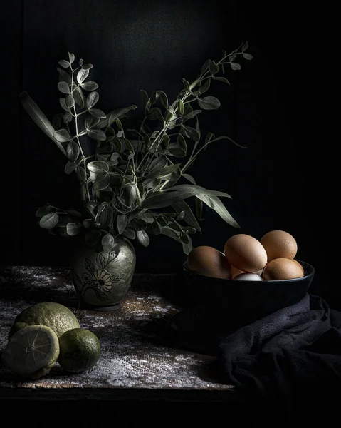 木のテーブルの上に花瓶に卵 レモン 植物の静物画 — ストック写真
