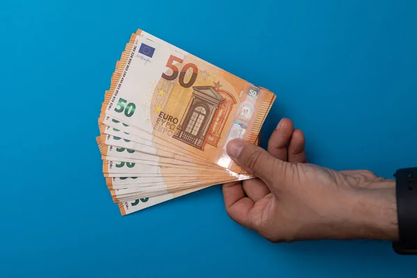 Person Holding Fifty Euro Banknotes Isolated Blue Background — Stock Photo, Image