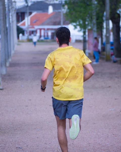 Een Verticaal Schot Van Een Man Rennend Een Straat — Stockfoto