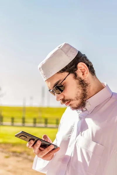 Vertikal Bild Ung Saudiarabisk Man Traditionella Kläder Med Telefon Händerna — Stockfoto