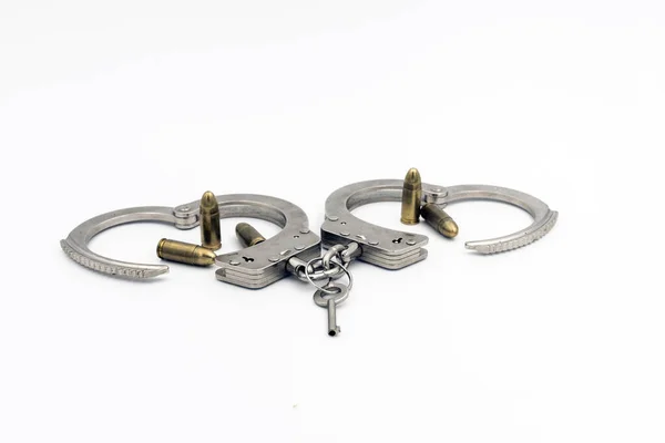 Eine Nahaufnahme Von Polizeihandschellen Aus Metall Und Kugeln Auf Weißem — Stockfoto