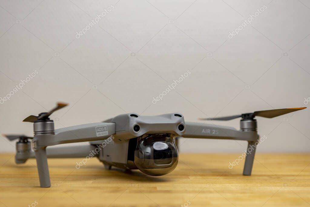 ZUTPHEN, NETHERLANDS - Aug 06, 2021: Quadcopter DJI Air 2S drone seen from the front with its gimbal protective round plastic cap on. Studio product still life of portable UAV.