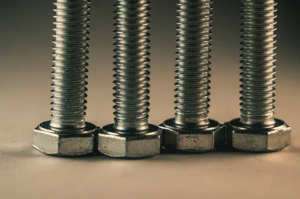 Selective Focus Shot Few Stainless Bolts Beige Surface — Stock Photo, Image