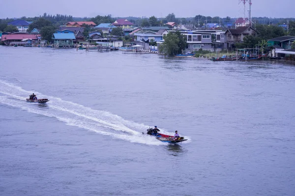 BANGKOK, THAILAND - Mar 12, 2020: Two Boats racing along the river during daybreak in Bangkok, Thailand