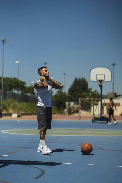 Young Caucasian Guy Cool Tattoos Holding His Neck Standing Basketball — Stock Photo, Image