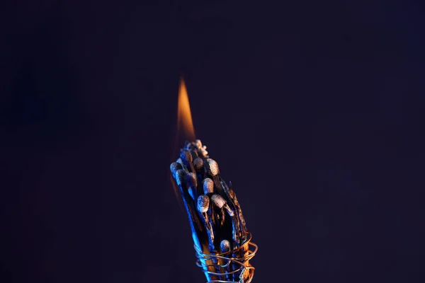 Closeup Shot Burning Matchsticks Connected Metal Wire Black Background — Stock Photo, Image