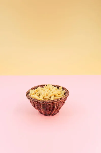 Shot Italian Torchiette Pasta Wicker Canister Pink Color Background — Stock Photo, Image