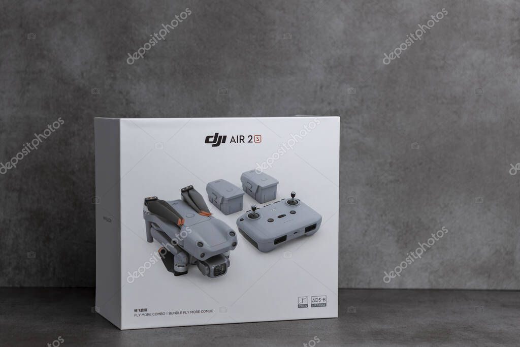 ZUTPHEN, NETHERLANDS - Aug 06, 2021: Studio RPS product still life of fly more combo package box of DJI portable quadcopter Air 2S drone on contemporary modern metallic patterned backdrop