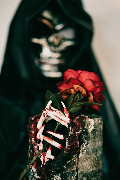 不気味なハロウィンの装飾の垂直ショット ケープ内の骨格によって保持される歯を持つ恐ろしいケーキ — ストック写真