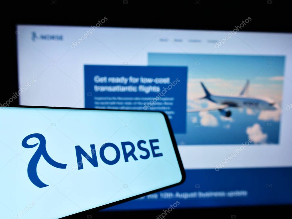 STUTTGART, GERMANY - Aug 15, 2021: Mobile phone with logo of Norwegian airline Norse Atlantic Airways on screen in front of website. Focus on center-left of phone display.