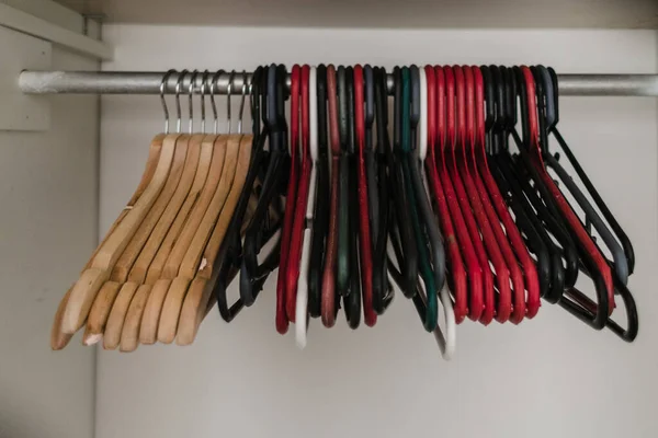 Closeup Different Colored Plastic Hangers Next Wooden Ones Closet — Stock Photo, Image