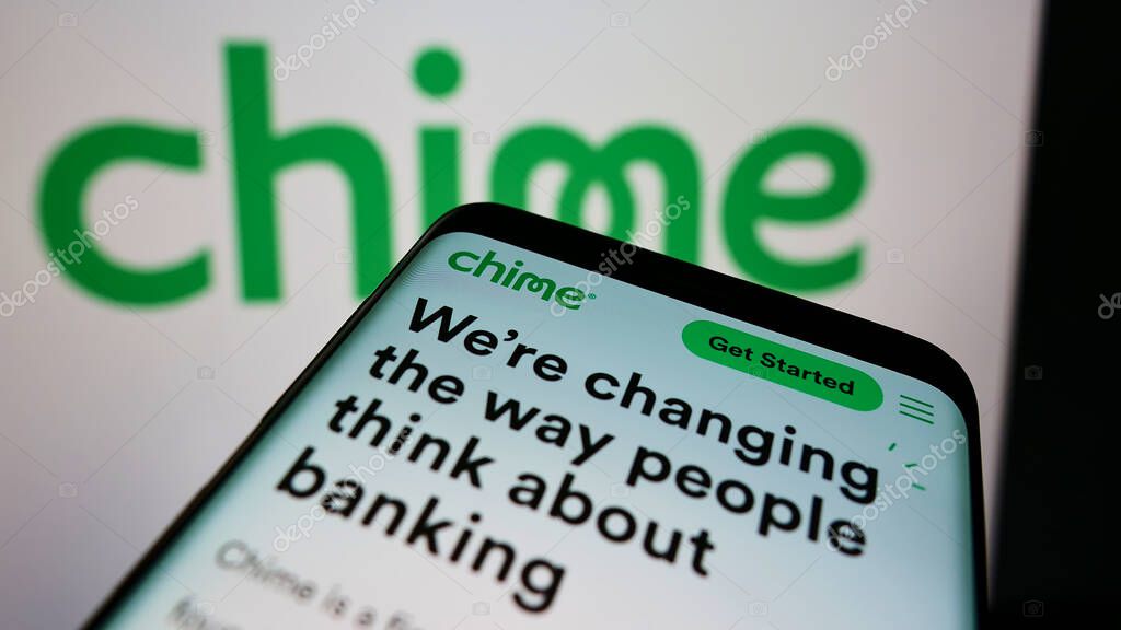 STUTTGART, GERMANY - Aug 18, 2021: Mobile phone with webpage of fintech company Chime Financial Inc. on screen in front of logo. Focus on top-left of phone display.